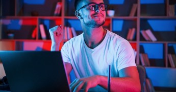Man smiling using laptop, privacy champion, Security champion, blog, sales