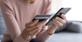 Consumer using phone to pay, woman, smartphone